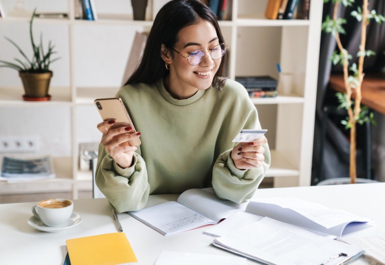Girl shopping on mobile phone with credit card