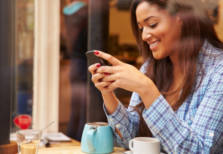 Woman on her phone in a coffee shop