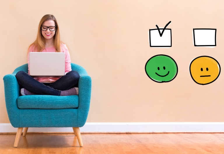 woman wearing glasses is taking surveys using her laptop